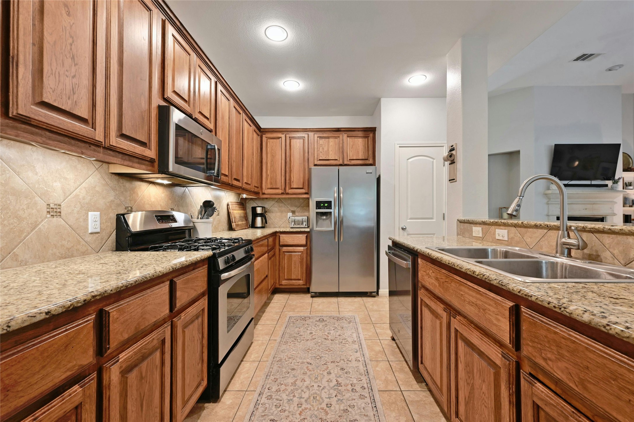 130 Farm House Road San Marcos, TX 78666 - Photo 7 of 34 a kitchen with stainless steel appliances granite countertop a sink stove and refrigerator