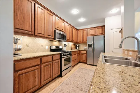 a kitchen with granite countertop a sink and a stove