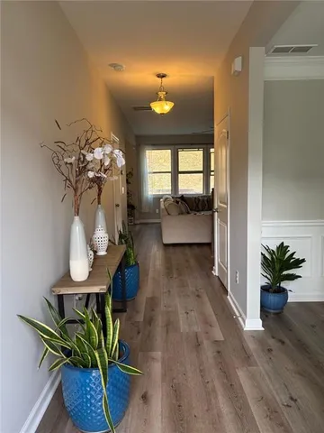 a view of a dining room with furniture a chandelier and wooden floor