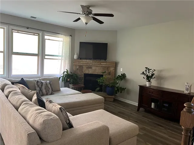 a living room with furniture a fireplace and a flat screen tv