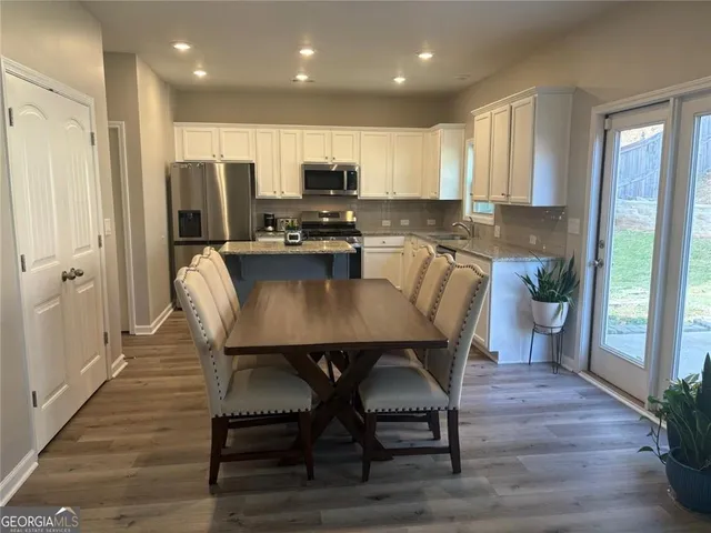a view of a dining room with furniture and wooden floor