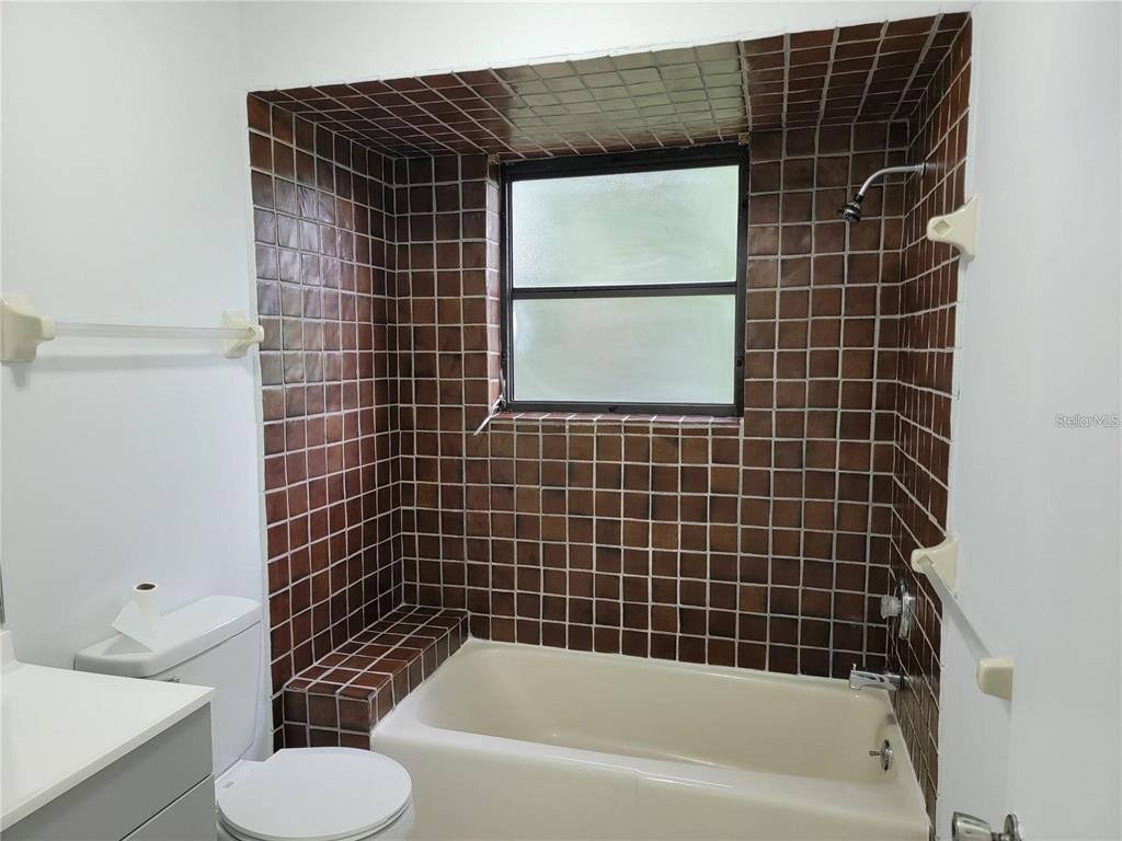 26221 Constantine Road Punta Gorda, FL 33983 - Photo 19 of 27 a bathroom with a toilet and a bathtub