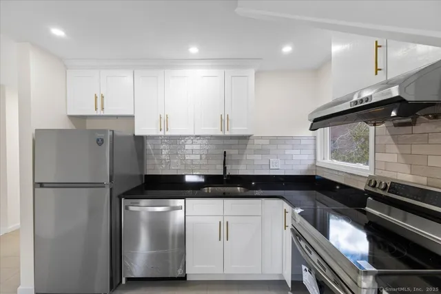 a kitchen with a refrigerator and a sink