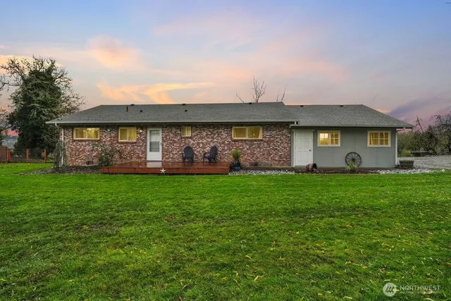 a front view of house with yard and outdoor seating