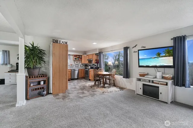 a kitchen with a table chairs stove and refrigerator