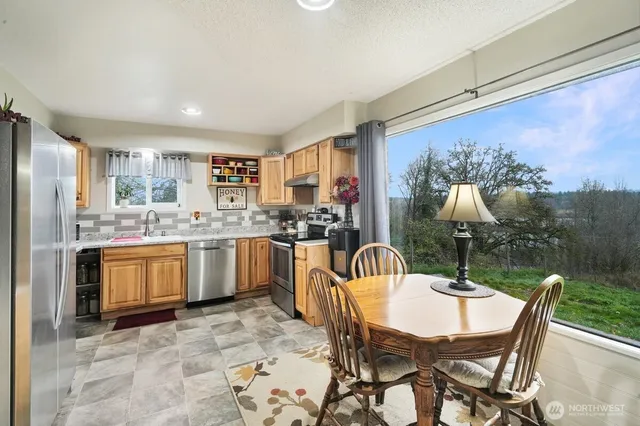a kitchen with stainless steel appliances granite countertop a stove a sink dishwasher and a refrigerator