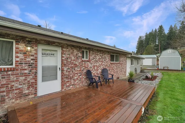 a view of a house with a yard and sitting area