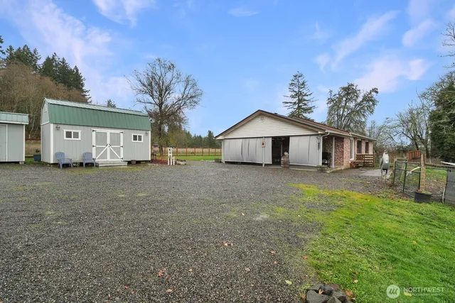 a view of house with backyard and trees