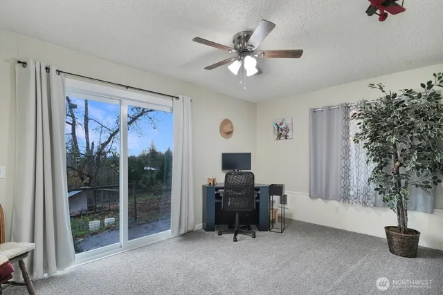a view of a livingroom with workspace and a window