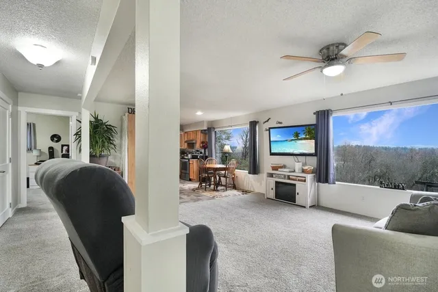 a living room with furniture large window and flat screen tv