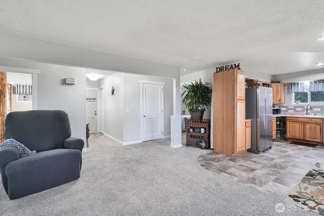 a view of kitchen with furniture and refrigerator