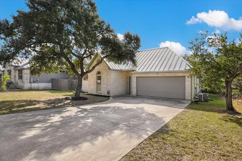 a view of a house with a yard and garage