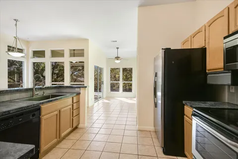 a kitchen with stainless steel appliances granite countertop a refrigerator and a sink
