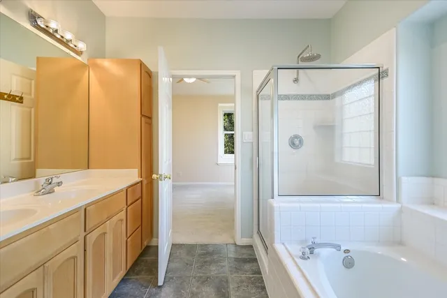 a bathroom with a bathtub and a shower