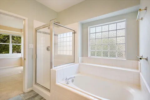 a bathroom with a bathtub and a shower