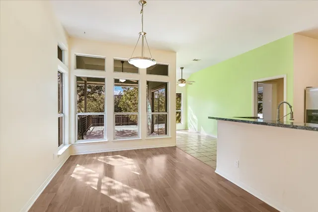 a view of a room with wooden floor and windows
