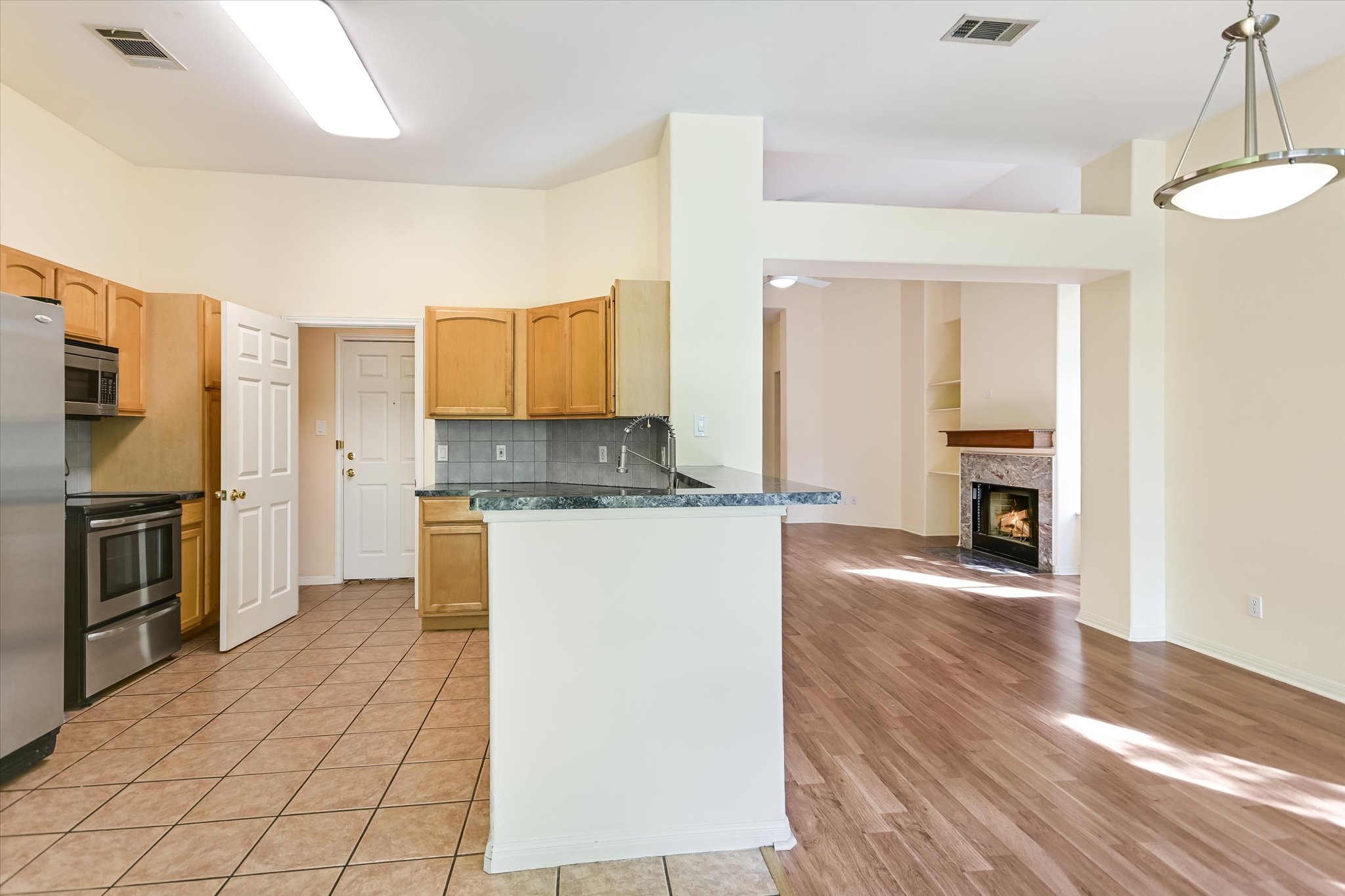 27 Indian Princess Wimberley, TX 78676 - Photo 9 of 25 a kitchen with granite countertop a refrigerator and a stove top oven