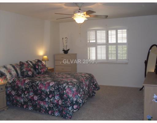 6591 Vigo Road Las Vegas, NV 89146 - Photo 7 of 17 Master Bedroom. Spacious master bedroom with a pool view.