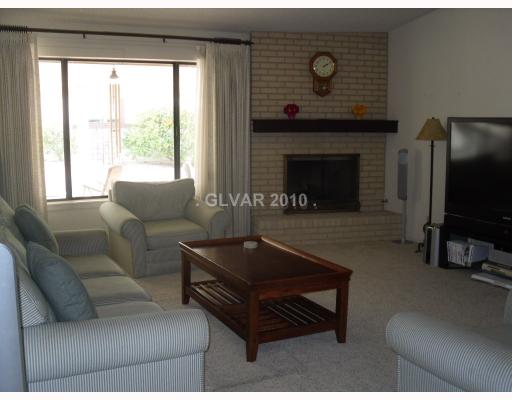 6591 Vigo Road Las Vegas, NV 89146 - Photo 9 of 17 Living Room. Delightful formal, front living room with a gas fireplace.