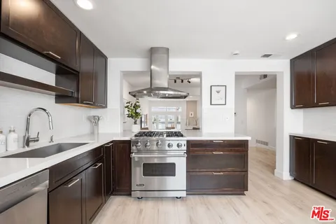 a kitchen with stainless steel appliances granite countertop a stove and a sink