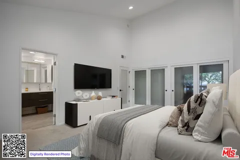 a bedroom with a bed and a flat screen tv