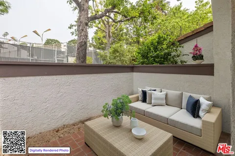 a view of a balcony with chairs and a potted plant