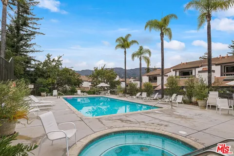 a swimming pool with outdoor seating and yard