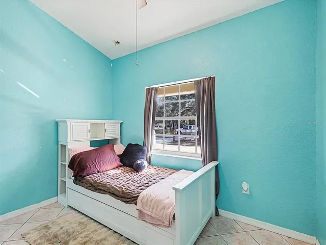 a bedroom with a bed and window