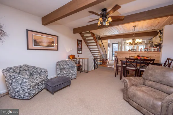 a living room with furniture and a chandelier