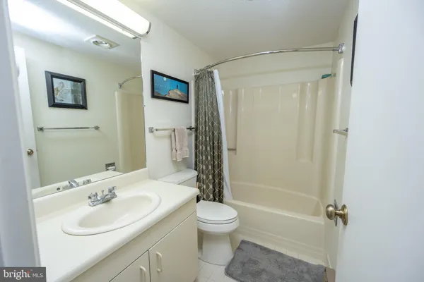 a bathroom with a sink toilet tub and shower