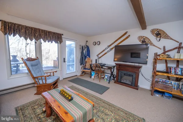 a view of a livingroom with furniture and a ceiling fan