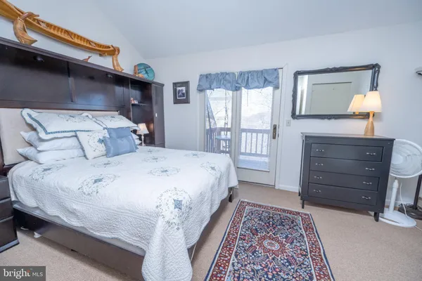 a bedroom with a bed and a television