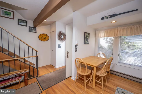 a view of a dining room with furniture window and wooden floor