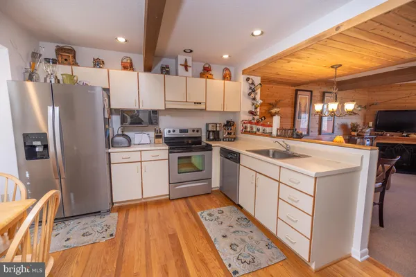 a kitchen with a sink appliances and cabinets