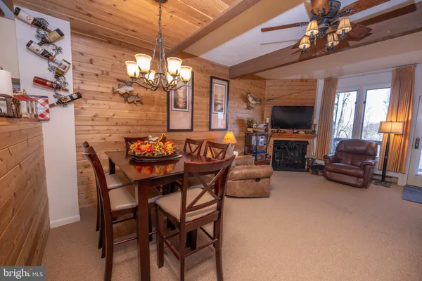 a view of a livingroom with furniture a flat screen tv and couches
