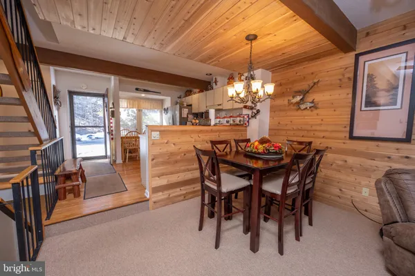 a view of a dining room with furniture and chandelier