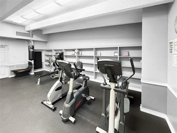 a room with gym equipment and a large window