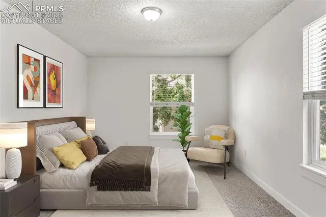 a bedroom with furniture and a window