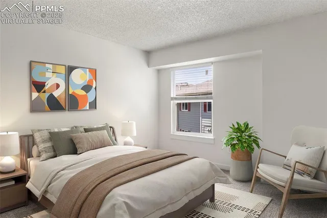 a bedroom with a bed and a painting on the wall