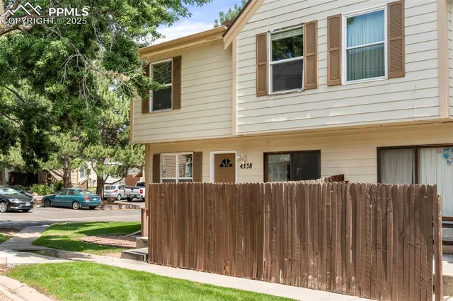 a view of a house with a backyard