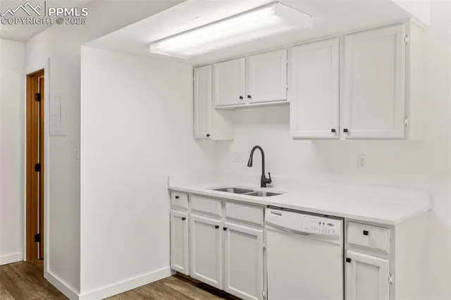 a kitchen with white cabinets