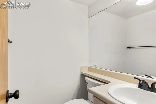 a bathroom with a sink a toilet and mirror