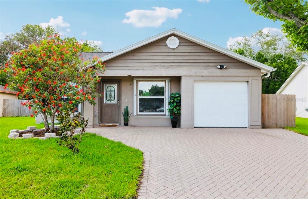 1525 Kestrel Way Brandon, FL 33511 - Photo 2 of 48 a front view of a house with a garden and yard