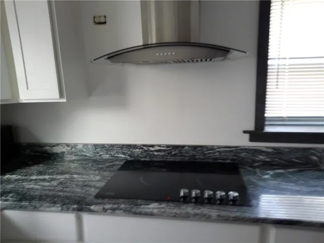 a kitchen with a sink a stove and a microwave