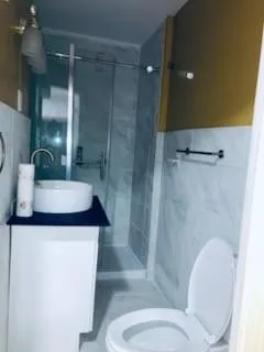 a kitchen with granite countertop white cabinets and black appliances