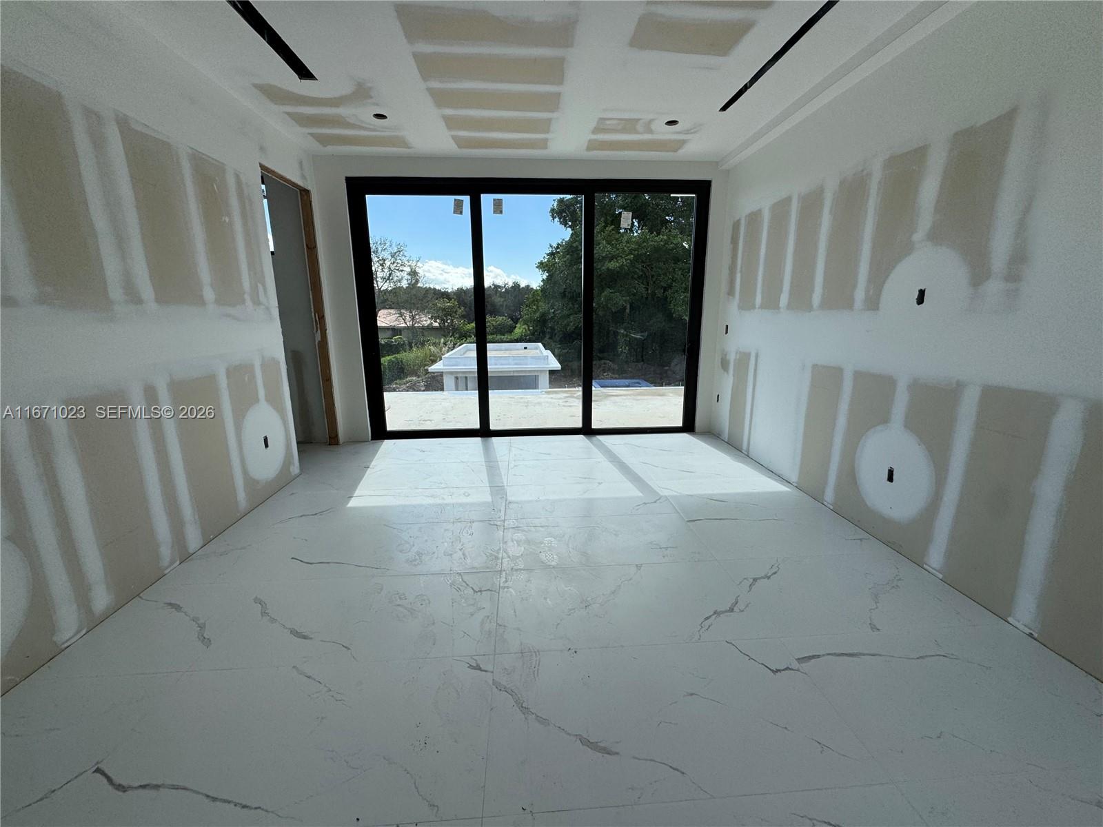 6666 Southwest 96th Street Pinecrest, FL 33156 - Photo 23 of 82 a view of an empty room with a window