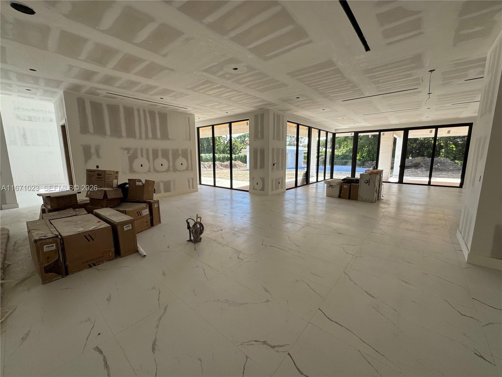6666 Southwest 96th Street Pinecrest, FL 33156 - Photo 76 of 82 a lobby with furniture and floor to ceiling window