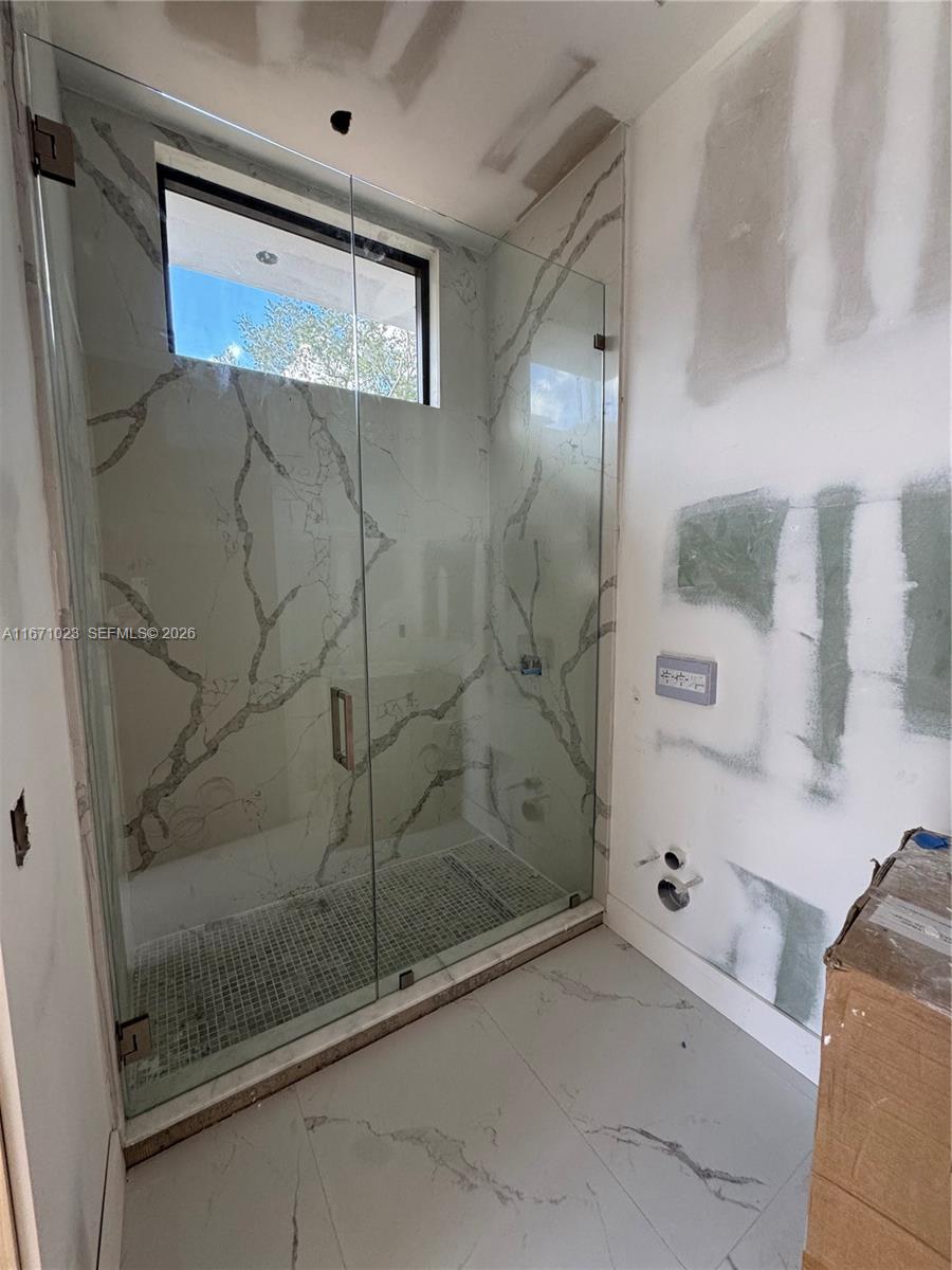 6666 Southwest 96th Street Pinecrest, FL 33156 - Photo 82 of 82 a bathroom with a bathtub and a shower