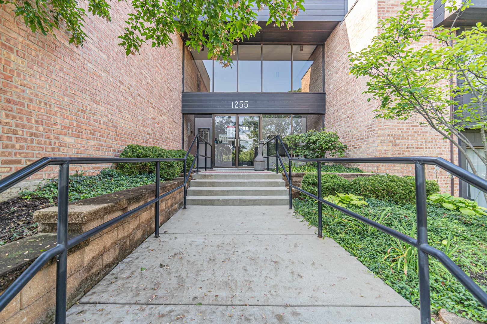 1255 North Sterling Avenue, Unit 201 Palatine, IL 60067 - Photo 2 of 22 a front view of a house with a yard
