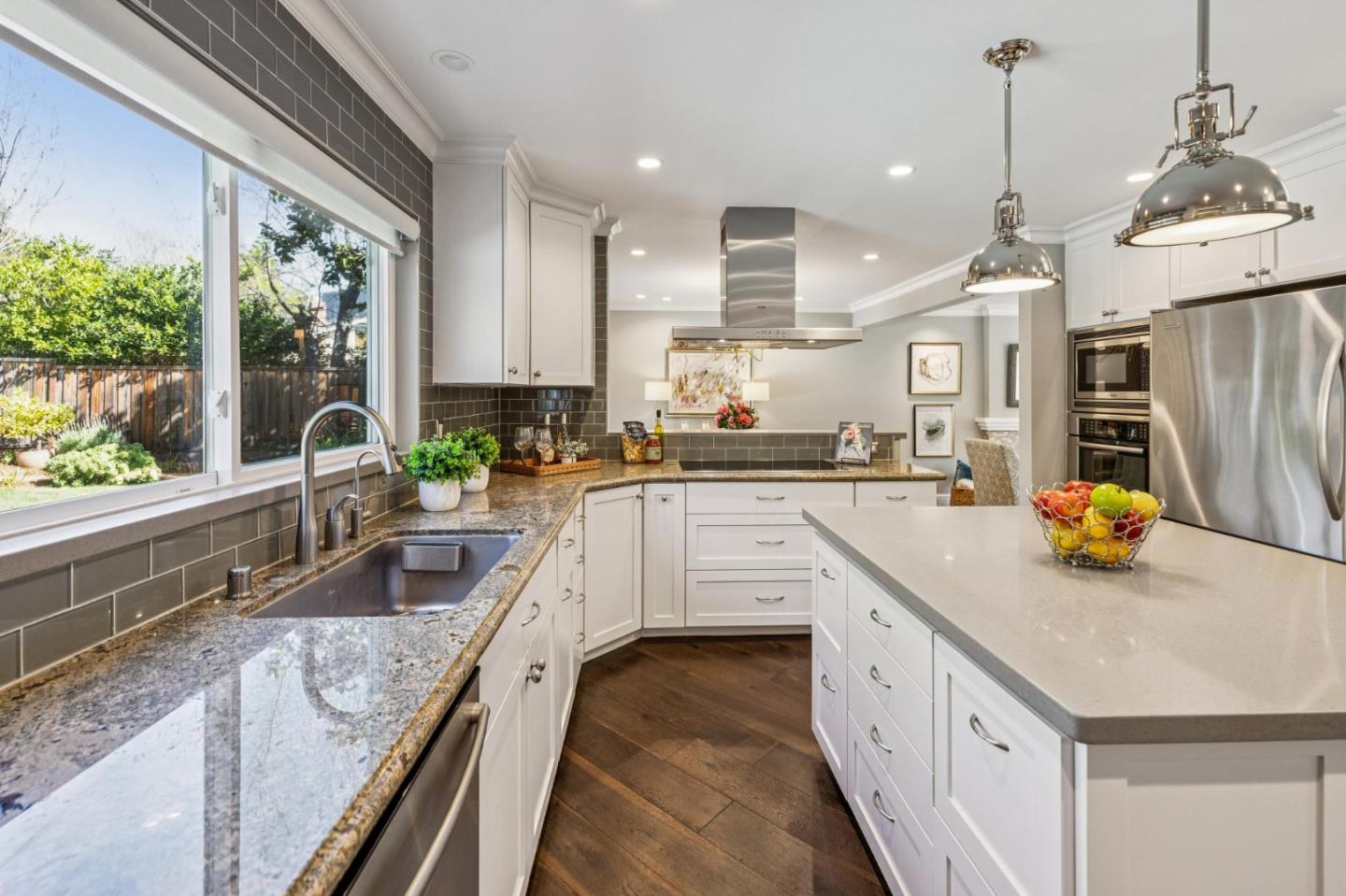 21685 Regnart Road Cupertino, CA 95014 - Photo 18 of 68 a kitchen with a sink a counter top space stainless steel appliances and a large window